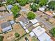 Aerial view showcases this property's layout, highlighting the fenced backyard and multiple outbuildings at 506 Richard St, Leesburg, FL 34748