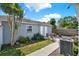 This backyard is very private and fully fenced, with a small patio, landscaping, and a charming walkway at 506 Richard St, Leesburg, FL 34748