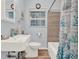 Updated bathroom with modern sink, toilet, and combination shower and bathtub at 506 Richard St, Leesburg, FL 34748