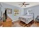 Comfortable bedroom with hardwood floors and ample natural light from two windows at 506 Richard St, Leesburg, FL 34748