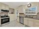 Well-lit kitchen features modern stainless steel appliances and neutral backsplash at 506 Richard St, Leesburg, FL 34748