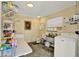 Functional laundry room with washer, sink, and extra storage space at 506 Richard St, Leesburg, FL 34748