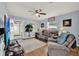 Comfortable living room showcasing hardwood floors, a ceiling fan, and an open doorway at 506 Richard St, Leesburg, FL 34748
