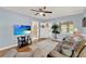 Comfortable living room showcasing hardwood floors, a ceiling fan, and an open doorway at 506 Richard St, Leesburg, FL 34748