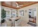 Cozy sun room features wood ceiling, tiled floors, a ceiling fan, and great natural light at 506 Richard St, Leesburg, FL 34748