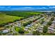 Gorgeous aerial view of a neighborhood with well-manicured lawns and mature trees, near a large field and lake at 5075 China Sea Dr, Tavares, FL 32778