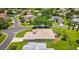 An aerial view showcases the rear of the home, the screened in lanai, and lush landscaping at 5075 China Sea Dr, Tavares, FL 32778
