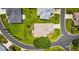 Aerial view of home's roof, landscaping, and circular drive in a well-maintained, green neighborhood at 5075 China Sea Dr, Tavares, FL 32778
