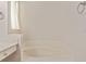 Bathroom featuring a soaking tub with tiled platform at 5075 China Sea Dr, Tavares, FL 32778