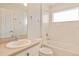 Bright bathroom featuring a sink, toilet, and bathtub with tiled walls at 5075 China Sea Dr, Tavares, FL 32778