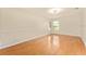 Bright bedroom with wood floors and two windows overlooking the yard at 5075 China Sea Dr, Tavares, FL 32778