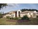 Inviting single-story home with a screened entrance and well-maintained landscaping at 5075 China Sea Dr, Tavares, FL 32778