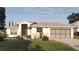 Charming single-story home boasts a well-manicured lawn and an inviting screened entryway and two-car garage at 5075 China Sea Dr, Tavares, FL 32778
