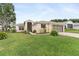 Charming single-story home with a lush green lawn and an attached two-car garage at 5075 China Sea Dr, Tavares, FL 32778