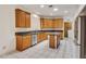 Spacious kitchen with light-colored wood cabinets, stainless steel appliances, and a granite countertop at 5075 China Sea Dr, Tavares, FL 32778