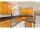 Well-lit kitchen features granite countertops, wood cabinets, stainless steel appliances and a center island at 5075 China Sea Dr, Tavares, FL 32778