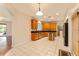 Large kitchen with stainless appliances, wooden cabinets, granite countertops and tile flooring at 5075 China Sea Dr, Tavares, FL 32778