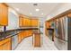 Bright kitchen with stainless steel appliances, central island, granite counters, and tile flooring at 5075 China Sea Dr, Tavares, FL 32778