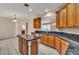 Spacious kitchen with tiled floor, stainless steel appliances, granite countertops, and an island at 5075 China Sea Dr, Tavares, FL 32778