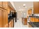 Spacious kitchen with stainless steel appliances, wooden cabinets, granite countertops, and center island at 5075 China Sea Dr, Tavares, FL 32778