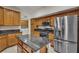 Traditional kitchen with stainless steel appliances, granite countertops, and a center island at 5075 China Sea Dr, Tavares, FL 32778