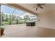 Screened lanai features a hot tub, providing an outdoor living space with views of the landscaped backyard at 5075 China Sea Dr, Tavares, FL 32778