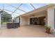 Enjoy outdoor living on this screened lanai with a hot tub, connecting seamlessly to the home's interior at 5075 China Sea Dr, Tavares, FL 32778