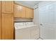 Well-equipped laundry room features ample cabinet storage and a full-size washer and dryer for convenience at 5075 China Sea Dr, Tavares, FL 32778
