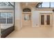 Covered front patio area with a screen, an exterior door and wall sconces at 5075 China Sea Dr, Tavares, FL 32778
