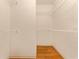 Spacious walk-in closet with installed shelving and wood floors at 5075 China Sea Dr, Tavares, FL 32778