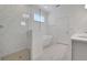 Modern bathroom featuring a glass-enclosed shower, soaking tub, and dual vanities, blending style and functionality at 5105 Blanket Flower St, Apopka, FL 32712