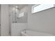Modern bathroom featuring a soaking tub and glass-enclosed shower with marble tile surround at 5105 Blanket Flower St, Apopka, FL 32712