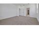 Spacious carpeted bedroom with neutral walls and multiple entry points at 5105 Blanket Flower St, Apopka, FL 32712