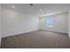 A bright bedroom features neutral carpet, white walls, a large window, and recessed lighting for a cozy, welcoming space at 5105 Blanket Flower St, Apopka, FL 32712