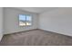 Bright bedroom features neutral carpet, white walls and a large window with views of new home construction at 5105 Blanket Flower St, Apopka, FL 32712