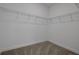 Walk-in closet features neutral carpet, white walls and ample shelving for a functional storage solution at 5105 Blanket Flower St, Apopka, FL 32712