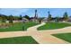 Dog park featuring paved paths, grassy areas, and pet waste stations for community enjoyment at 5105 Blanket Flower St, Apopka, FL 32712