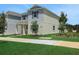 Side view of a two-story home featuring green grass, young tree and a landscaped area at 5105 Blanket Flower St, Apopka, FL 32712