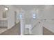 The hallway features neutral carpet, white walls, and a view of the adjacent bathroom and bedroom at 5105 Blanket Flower St, Apopka, FL 32712