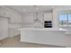 Modern kitchen with white cabinetry, stainless steel appliances, and quartz countertops at 5105 Blanket Flower St, Apopka, FL 32712