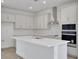 Open concept kitchen with a large island, white cabinets, and stainless appliances at 5105 Blanket Flower St, Apopka, FL 32712