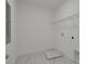 Functional laundry room with tile flooring and built-in storage solutions at 5105 Blanket Flower St, Apopka, FL 32712