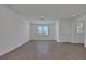 Bright living room with wood-look tile floors, recessed lighting, and a front door at 5105 Blanket Flower St, Apopka, FL 32712