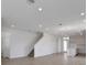 Spacious living room with hardwood flooring, staircase, and adjacent kitchen with island at 5105 Blanket Flower St, Apopka, FL 32712