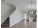 Open-concept living space with tile flooring, staircase, and a kitchen with an island at 5105 Blanket Flower St, Apopka, FL 32712