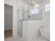 Modern bathroom featuring a glass-enclosed shower, a soaking tub, and white marble-style tiling at 5125 Waypointe Blvd, Apopka, FL 32712