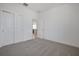 Bright bedroom with large sliding door closet, neutral carpet, and white walls at 5125 Waypointe Blvd, Apopka, FL 32712