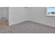 A well-lit bedroom features a sliding door closet, carpet, and white walls at 5125 Waypointe Blvd, Apopka, FL 32712