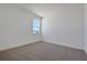 Bright bedroom featuring neutral carpet, white trim, and a sun-lit window at 5125 Waypointe Blvd, Apopka, FL 32712