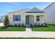 Charming single-story home with manicured lawn, walkway, and covered entrance, creating inviting curb appeal at 5125 Waypointe Blvd, Apopka, FL 32712